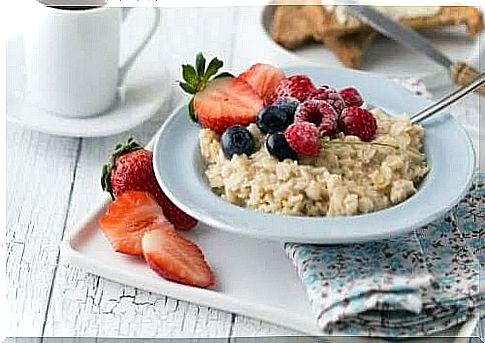 A healthy breakfast includes fruit and berries, and may also include a serving of oatmeal, for example.