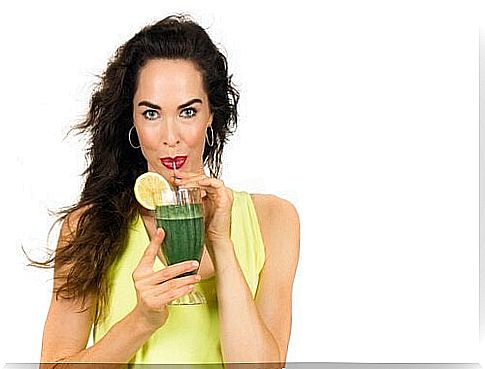 Woman drinking green smoothie